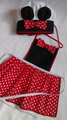 three pieces of minnie mouse costume on a white bed with polka dot sheets and headbands