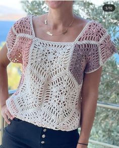 a woman wearing a crochet top and jeans