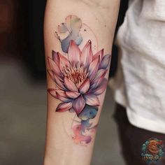 a woman's arm with a pink flower tattoo on it