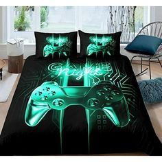 a bed with two pillows that have video game controllers printed on the front and sides