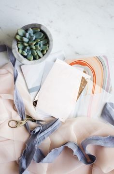 an assortment of fabric, scissors and other items laid out on top of each other