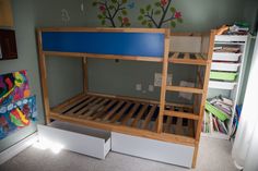 a wooden bunk bed sitting in a bedroom