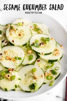 a white bowl filled with sliced cucumber salad