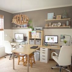 a home office with two computer desks and shelves on the wall, along with an open window