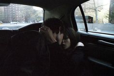 a man and woman kissing in the back seat of a car, with text above them