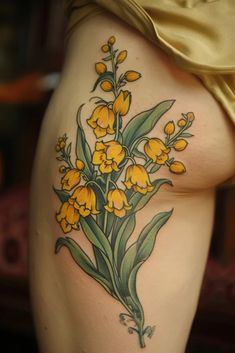 a woman's thigh with yellow flowers on it