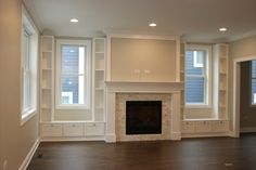 empty living room with fireplace and built in bookshelves