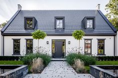 a white house with black shutters and windows