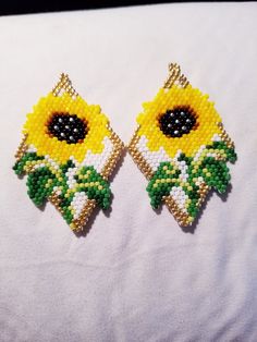 Pretty yellow sunflower in full bloom.  These earrings are two and a half inches long and an inch and a half wide.  Made with glass beads and Wildfire beading thread. Yellow Flower Shaped Jewelry With Sunflower Print, Yellow Flower-shaped Jewelry With Sunflower Print, Yellow Sunflower Dangle Earrings, Yellow Sunflower Design Dangle Earrings, Bohemian Yellow Sunflower Earrings, Yellow Beaded Flower Earrings, Yellow Flower Earrings With Colorful Beads, Yellow Flower-shaped Beaded Earrings, Handmade Yellow Flower Beaded Earrings