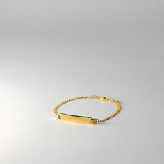 Introducing our exquisite Real 14K Gold ID Bracelet with Cuban Link - a striking blend of modern style and timeless sophistication. This bracelet is a testament to meticulous craftsmanship, not just as a piece of jewelry, but as a symbol of personal identity and enduring elegance. Your Unique Signature: Our Gold ID Bracelet offers a personal touch with an engraved ID tag, allowing you to carry a name, a special date, or a cherished word that holds sentimental value for you. The Cuban Link design