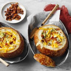 two bread bowls filled with cheese and meat