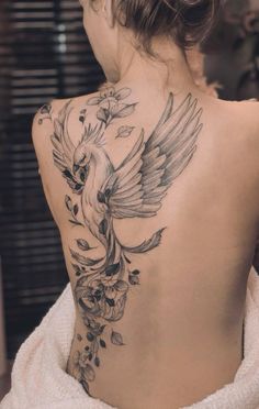 a woman with a bird tattoo on her back