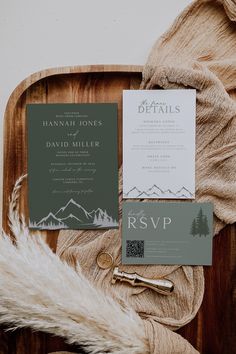 the wedding stationery is laid out on a wooden platter with fur and other items