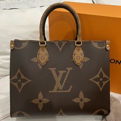 Louis Vuitton On The Go Mm Tote Great Condition Minor Scratch Towards The Bottom Front Inside In Excellent Condition Comes With Original Shopping Bag, Box, And Dust Bag Light Luxury Monogram Canvas Tote Bag, Luxury Top Handle Monogram Canvas Bags, Luxury Bag With Signature Coated Canvas And Handles, Luxury Bag In Signature Coated Canvas, Light Luxury Monogram Canvas Bag For Daily Use, Daily Use Light Luxury Monogram Canvas Bag, Luxury Monogram Canvas Bag With Detachable Handle, Luxury Signature Coated Canvas Bag With Handles, Luxury Signature Coated Canvas Bag