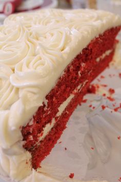 a slice of red velvet cake with white frosting