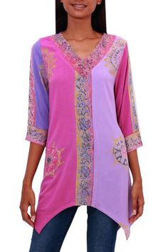 Perfect for covering up during temperate seasons this lovely tunic is created by Wayan Arta and Sharon in Bali. They craft this tunic from suave rayon decorated using the batik method; a wax resist is hand-stamped onto the fabric before it is treated with dyes resulting in vibrant hues of fuchsia lilac and violet decorated with elegant vine motifs. Bohemian Pink V-neck Kurta, Bohemian Pink Long Sleeve Tunic, Pink Bohemian Printed Tunic, Bohemian Pink Tunic With Floral Print, Purple Bohemian Tunic For Spring, Bohemian Purple Tunic For Spring, Bohemian Pink Kurta For Festival, Spring Bohemian Purple Kurta, Pink Long Sleeve Bohemian Kurta