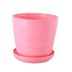 a pink cup sitting on top of a saucer