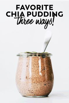 a jar filled with chia pudding on top of a white table next to a spoon