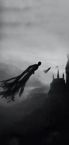 a black and white photo of a person flying in the air over a castle on a foggy day