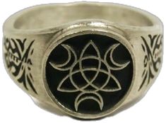 a silver ring with an image of a flower on the center and two circles in the middle