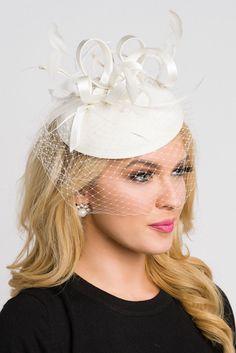 Be the envy of the party in this elegant felt fascinator. The round felt base is covered with satin ribbon loops, adorned with flighty feathers and topped off with a birdcage veil. This gorgeous piece is perfect for any special occasion. - Easy wear headband - Optional; tuck-a-way veil - Available in several other colors Wedding Guest Fascinators, Felt Fascinator, Fascinator Hats Outfit, Navy Blue Fascinator, Wedding Hats For Guests, Fascinator Hats Diy, Fascinator Hats Wedding, White Fascinator, Sinamay Hat