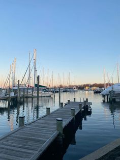 boats are docked in the water near a dock