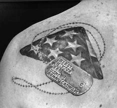 the back of a man's chest with an american flag and tags on it