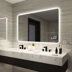 a modern bathroom with two sinks and a large mirror above the sink that is illuminated