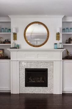 a living room filled with furniture and a fire place under a mirror on top of a mantle