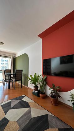 a living room filled with furniture and a flat screen tv mounted to the side of a wall