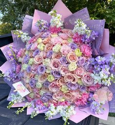 a bunch of flowers that are on top of a car