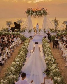 the bride and groom are walking down the aisle at their wedding ceremony in front of an audience