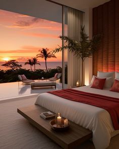 a bed sitting next to a window in a bedroom under a sky filled with clouds