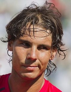 a close up of a tennis player wearing a red shirt