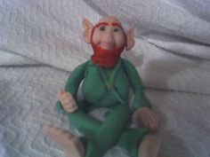 a toy elf sitting on top of a bed