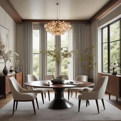 a dining room table with white chairs and a chandelier hanging from the ceiling