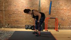 a woman is doing exercises in the gym