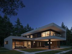 a modern house with large windows at night