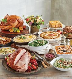 a table full of food including turkey and other foods