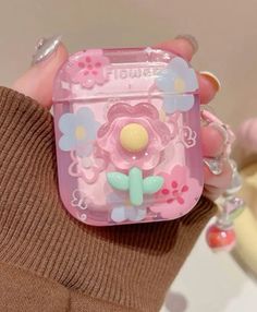 a person holding a pink case with flowers on it