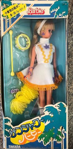 a barbie doll in a white dress with yellow hair and mop on the floor