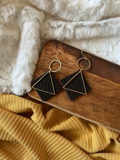 "These leather triangle earrings are 1.5\" in length.  Super lightweight and fun!  This listing is for one pair of Black leather accented with a brass circle and triangle.  They are real leather and come in Gray, Black, Light and Dark Brown.   - Choice of Gold Plated, Gold Fill or Brass Ear Wires - Genuine Leather  - Brass Circle and Triangle These earrings will be ready to ship within 3-5 days. Your little beauties will arrive in a box, ready for gift giving. Please let me know if you would like a little note attached!" Black Leather Drop Earrings, Leather Dangle Jewelry For Party, Trendy Black Earrings For Festivals, Trendy Black Festival Earrings, Party Leather Dangle Jewelry, Handmade Black Faux Leather Jewelry, Adjustable Black Faux Leather Earrings, Handmade Faux Leather Dangle Jewelry, Bohemian Adjustable Triangle Earrings