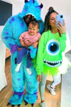 the woman is taking a selfie with her daughter and monster costume