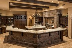 a large kitchen with stone counter tops and an island in front of the stove top