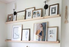 there are many framed pictures on the wall