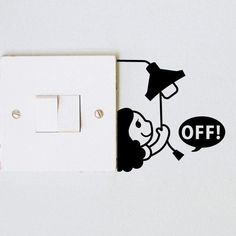 a white light switch sitting next to a black and white sticker with an off sign