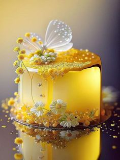 a yellow cake with white flowers and a butterfly on top