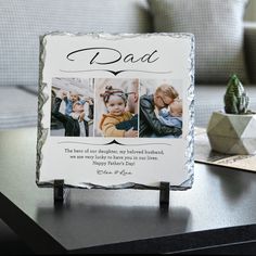 a photo frame sitting on top of a table next to a potted plant