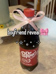 a bottle with a pink bow tied around it