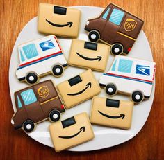 cookies decorated to look like cars and trucks are on a plate with an amazon logo